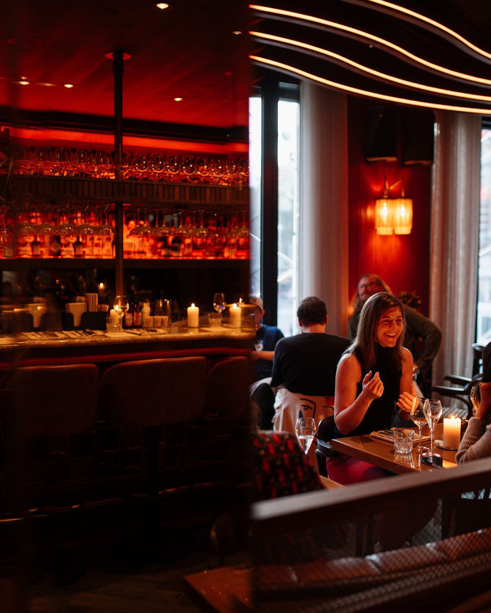 The red-lit bar with guests at tables in the evening
